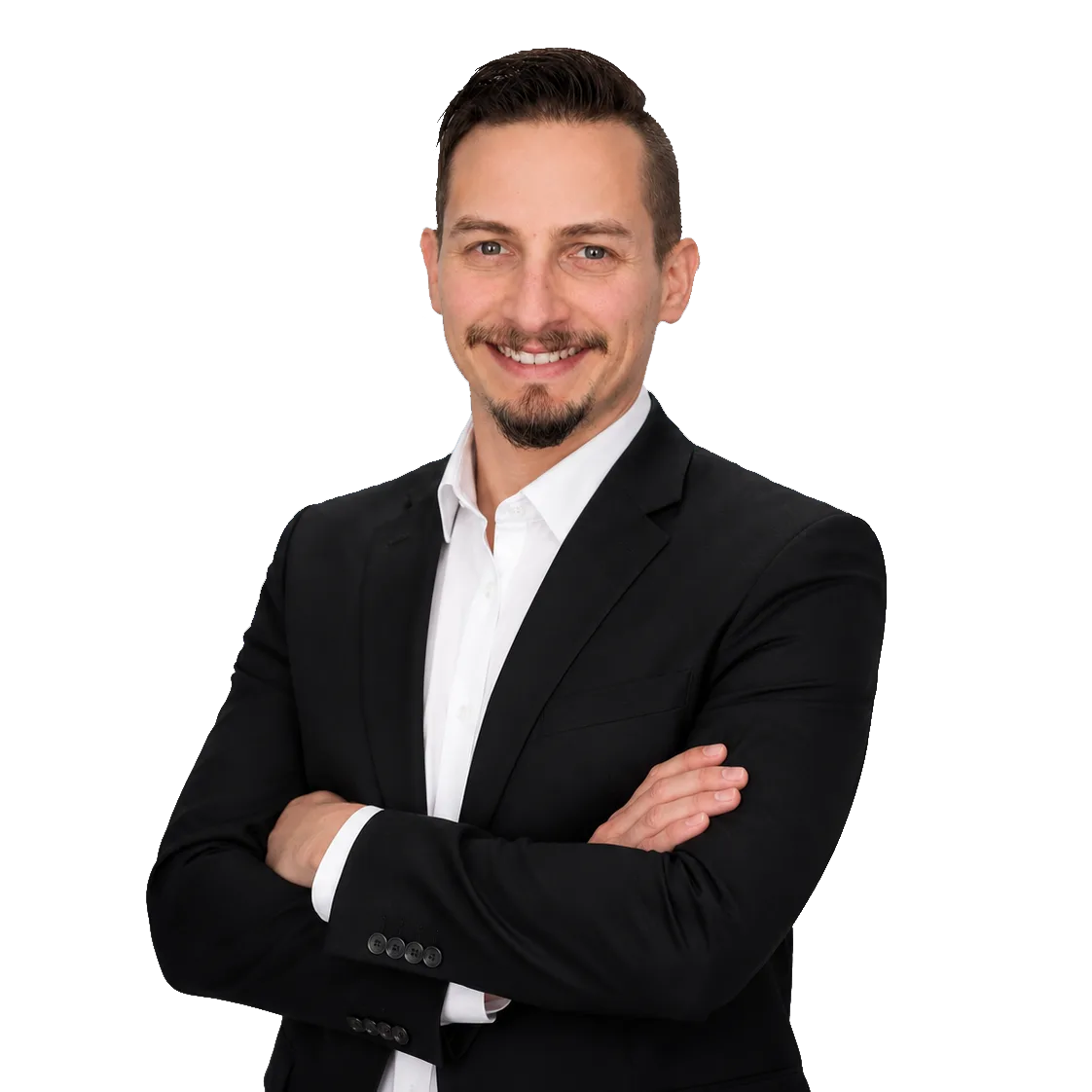 Patrick Domingues, CEO and Founder of Zevonix, standing with arms crossed in a professional business portrait wearing a black suit and white dress shirt.