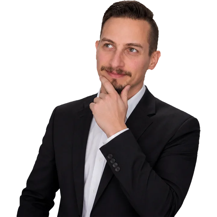 Patrick Domingues, CEO and Founder of Zevonix, in a thoughtful business portrait wearing a black suit and white dress shirt.